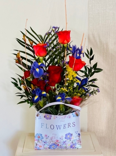 Gift bag of fresh flowers, with roses and other seasonal flowers, make a beautiful gift
